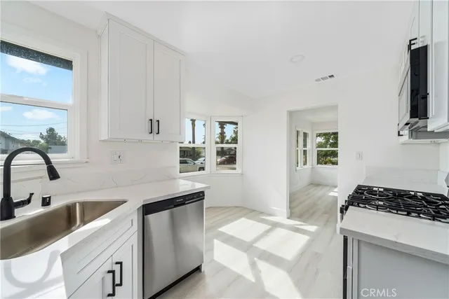 a kitchen with a sink stove and cabinets