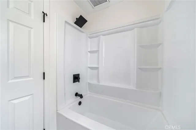 a white bath tub with a shower