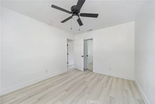 a view of room with a ceiling fan and hardwood floor