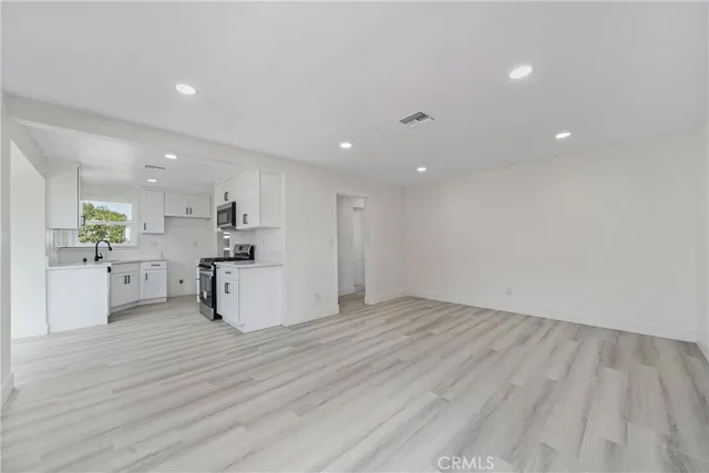 a view of kitchen with wooden floor and window