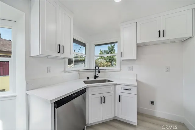 a kitchen with white cabinets and a sink