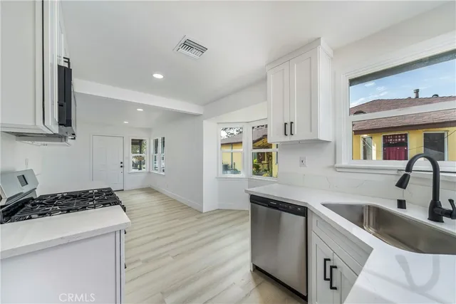 a kitchen that has a sink and a stove in it