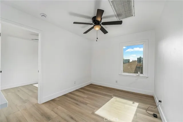 a kitchen with a refrigerator and white cabinets