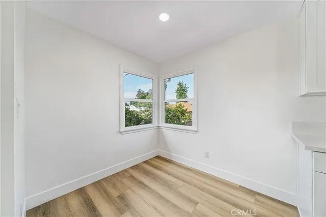 a kitchen with a sink a stove a refrigerator and white cabinets