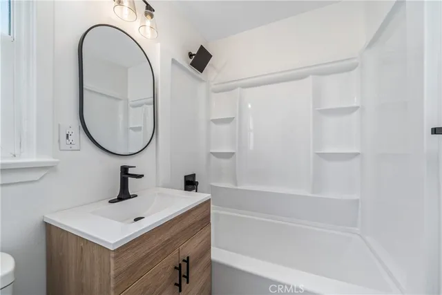 an empty room with a window and a ceiling fan