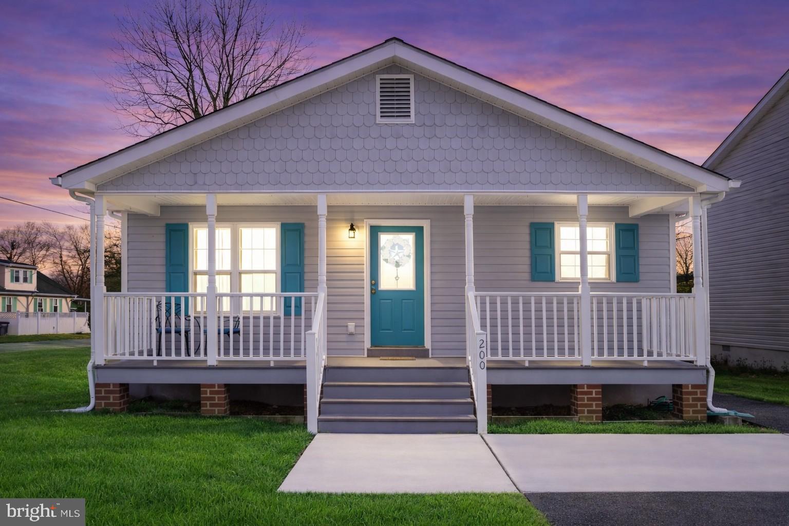 200 5th Street Colonial Beach, VA 22443 - Photo 1 of 45 Charming home with inviting porch at dusk.