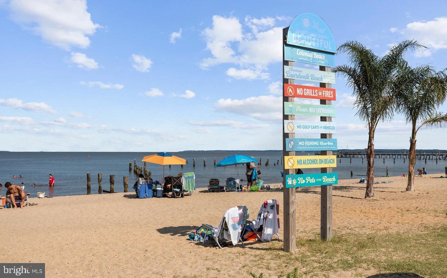 200 5th Street Colonial Beach, VA 22443 - Photo 33 of 45 Sunny beach day with vibrant signage.