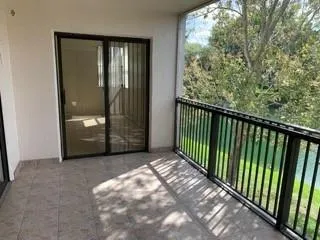 a view of a porch with wooden floor and windows