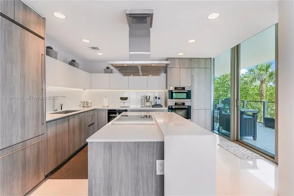 a kitchen with counter top space cabinets and appliances