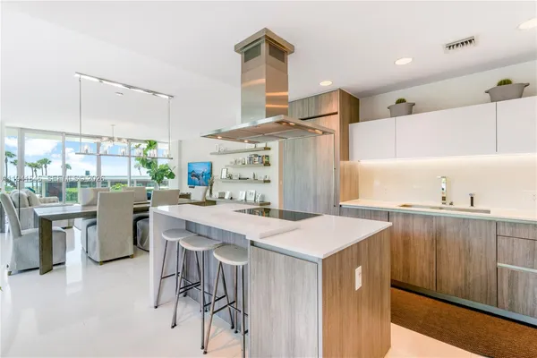 a kitchen with a stove a refrigerator and a dining table