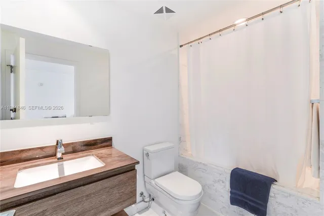 a bathroom with a toilet a sink and a mirror