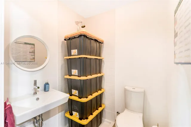 a bathroom with a toilet a sink and mirror