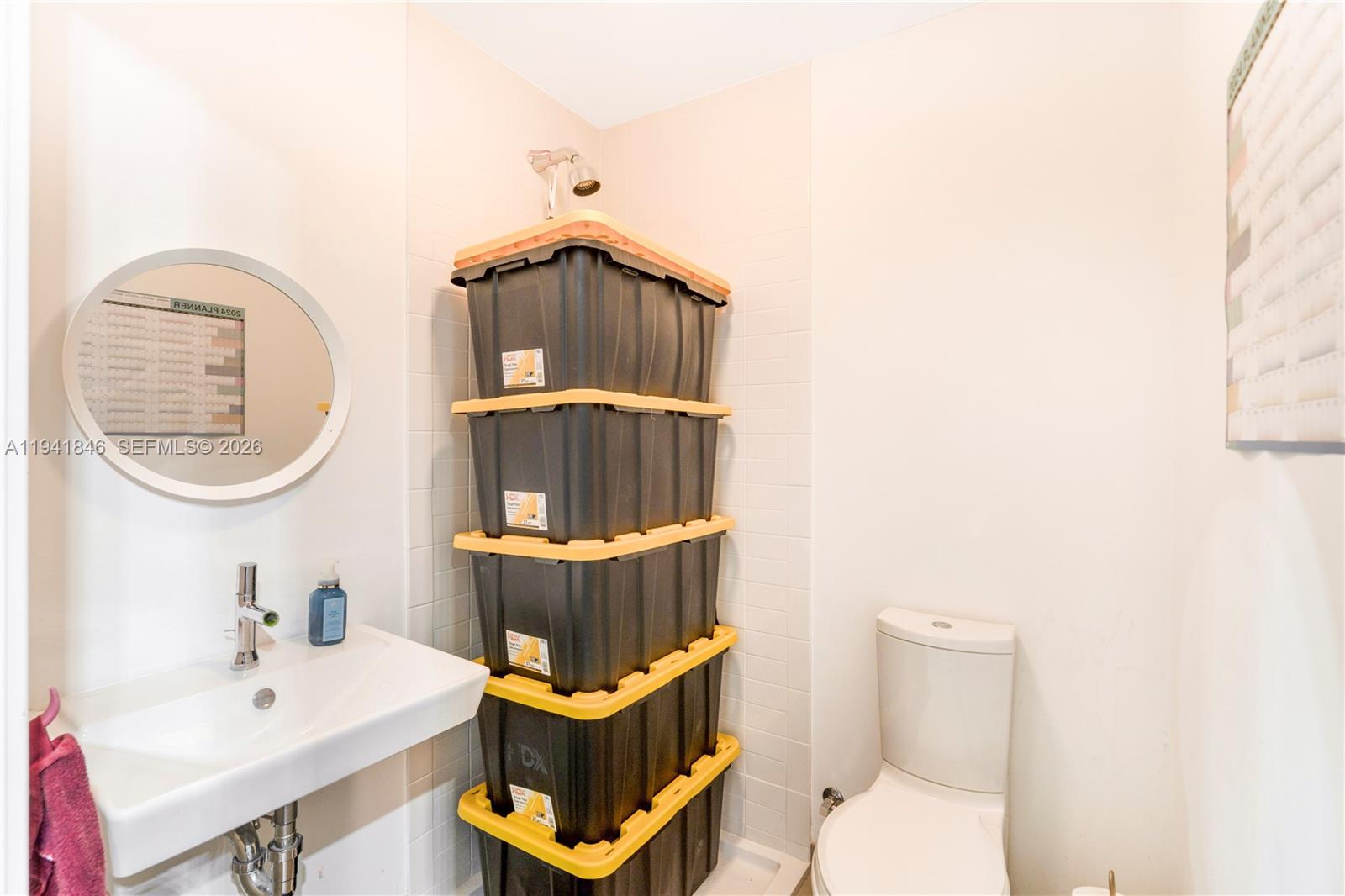 350 Ocean Drive, Unit 201N Key Biscayne, FL 33149 - Photo 22 of 46 a bathroom with a toilet a sink and mirror