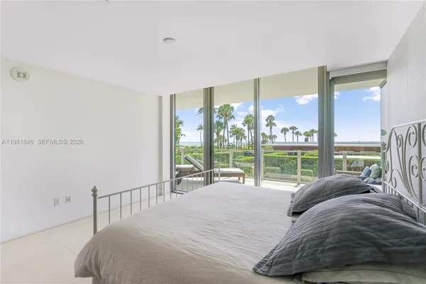 a bed sitting in a bedroom next to a large window