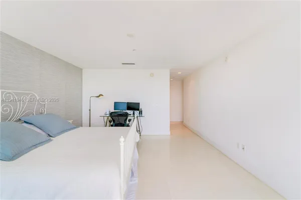 a view of a bedroom with a bed and a couch