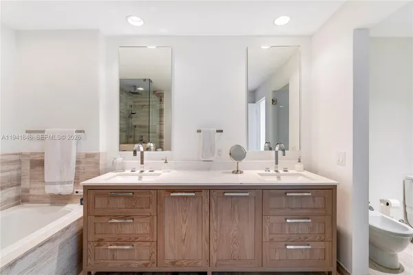 a bathroom with a double vanity sink and a mirror