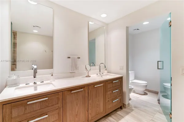 a bathroom with a double vanity sink and a mirror