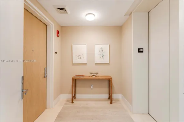 a view of a hallway with entryway door
