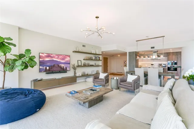a living room with furniture and a kitchen area