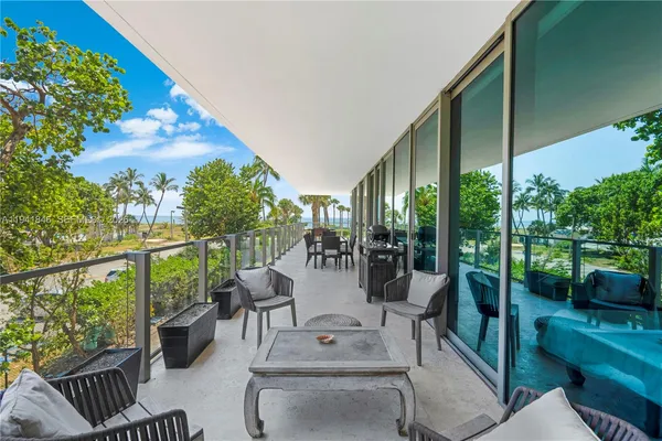 a view of a patio with couches table and chairs and potted plants
