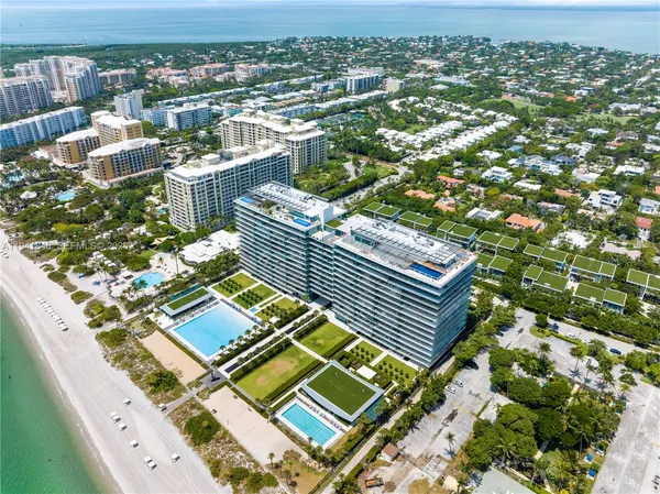 an aerial view of a residential apartment building with a yard