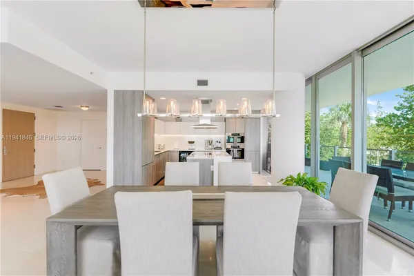 a kitchen with kitchen island stainless steel appliances a table and chairs