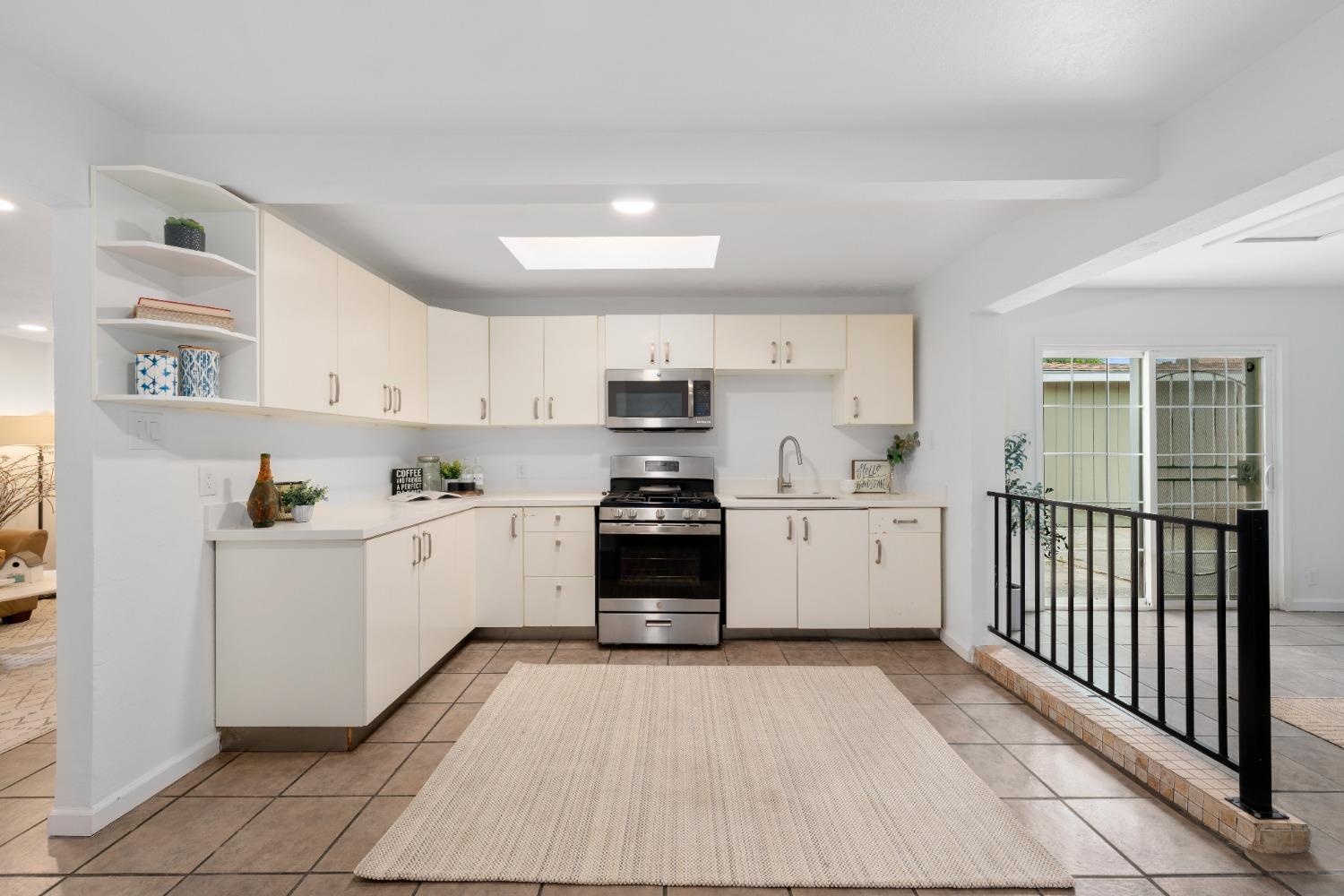 428 Q Q Rio Linda, CA 95673 - Photo 4 of 11 a kitchen with granite countertop white cabinets and white appliances
