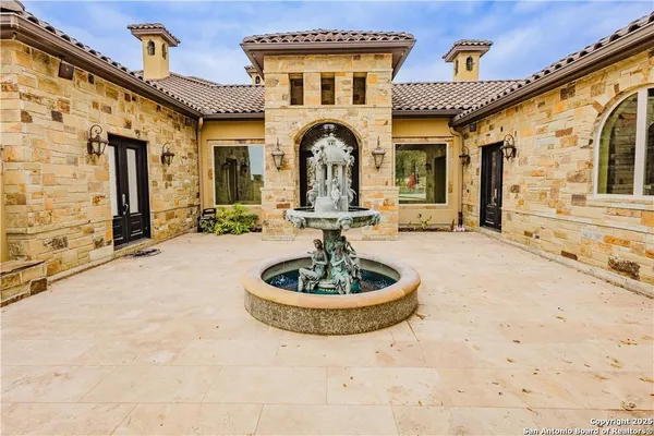 a front view of a house with a garden and patio