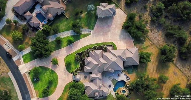 an aerial view of a house with outdoor space and a lake view