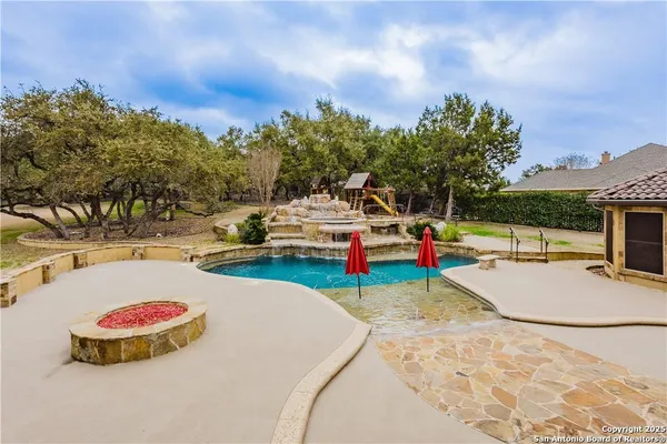 a kitchen with stainless steel appliances granite countertop a refrigerator a stove top oven a sink and dishwasher