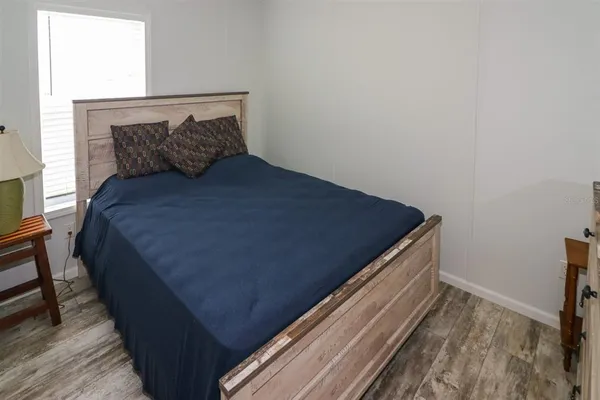 a bed sitting in a bedroom next to a window