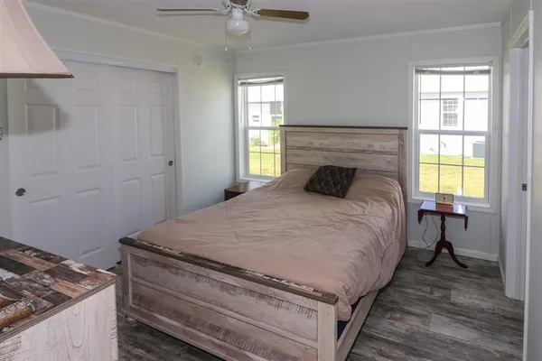 a bedroom with a bed and a mirror on dresser