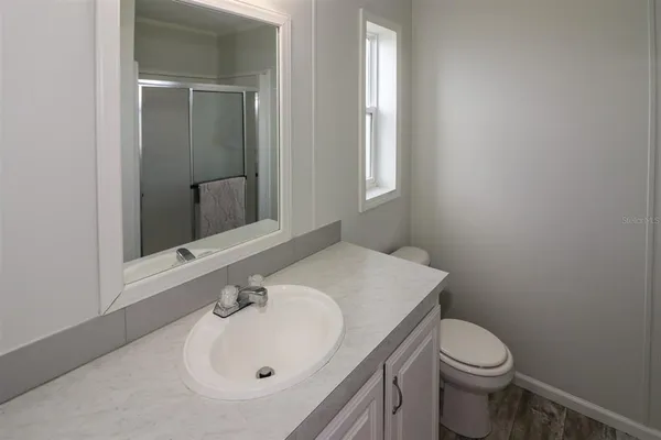 a bathroom with a toilet and a shower