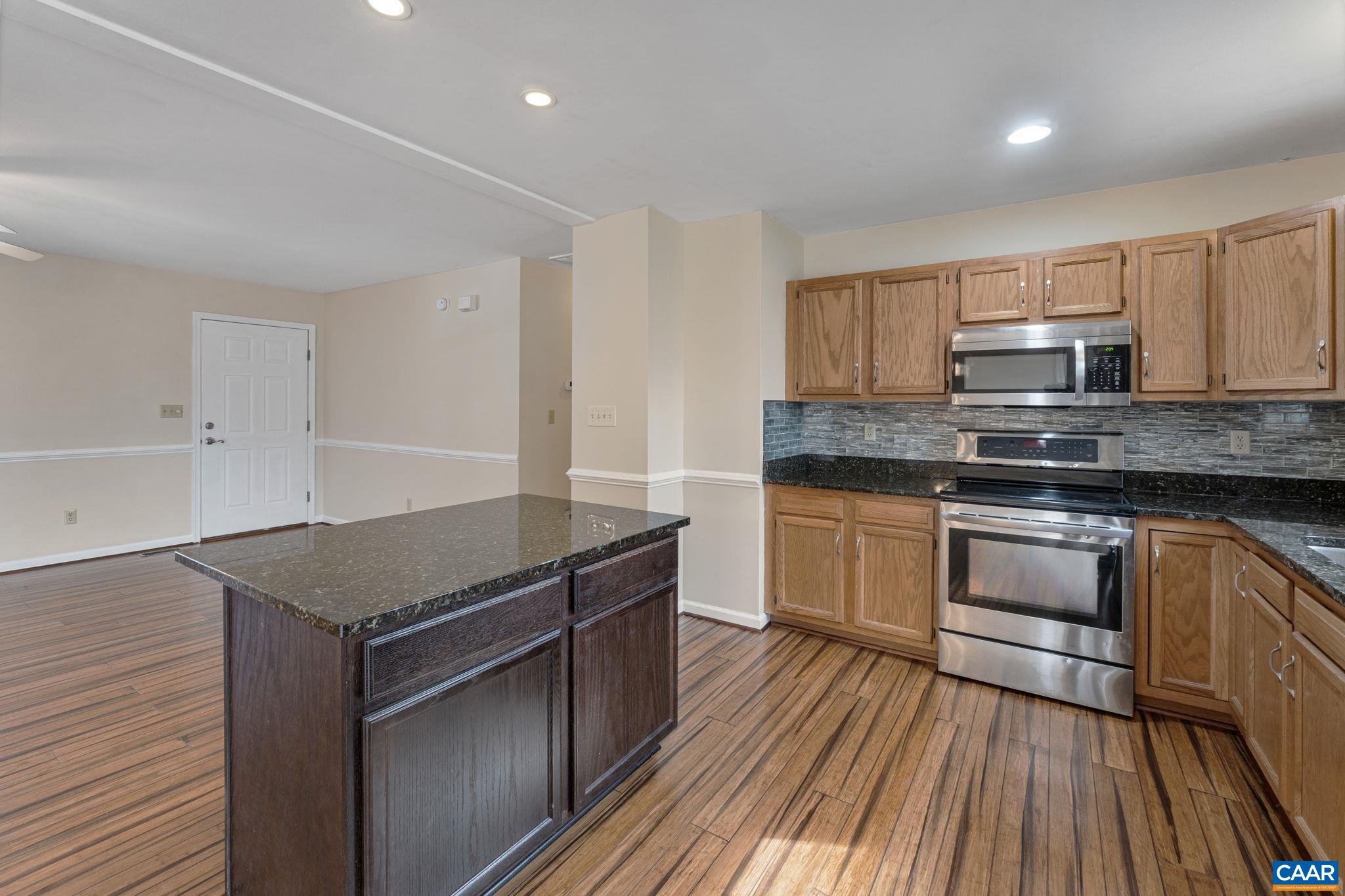 7 Riverside Drive Palmyra, VA 22963 - Photo 11 of 26 a kitchen with stainless steel appliances granite countertop a stove top oven a sink and white cabinets
