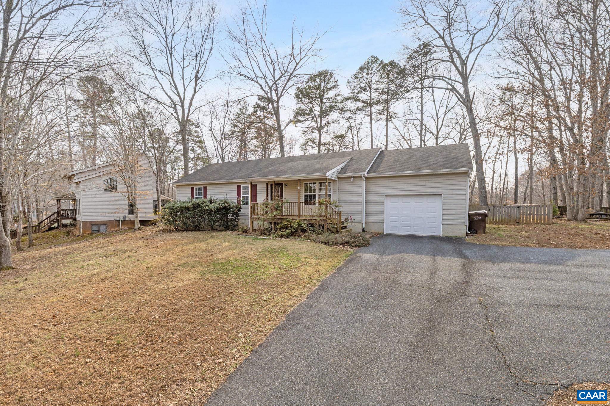 7 Riverside Drive Palmyra, VA 22963 - Photo 2 of 26 a front view of a house with a yard and garage