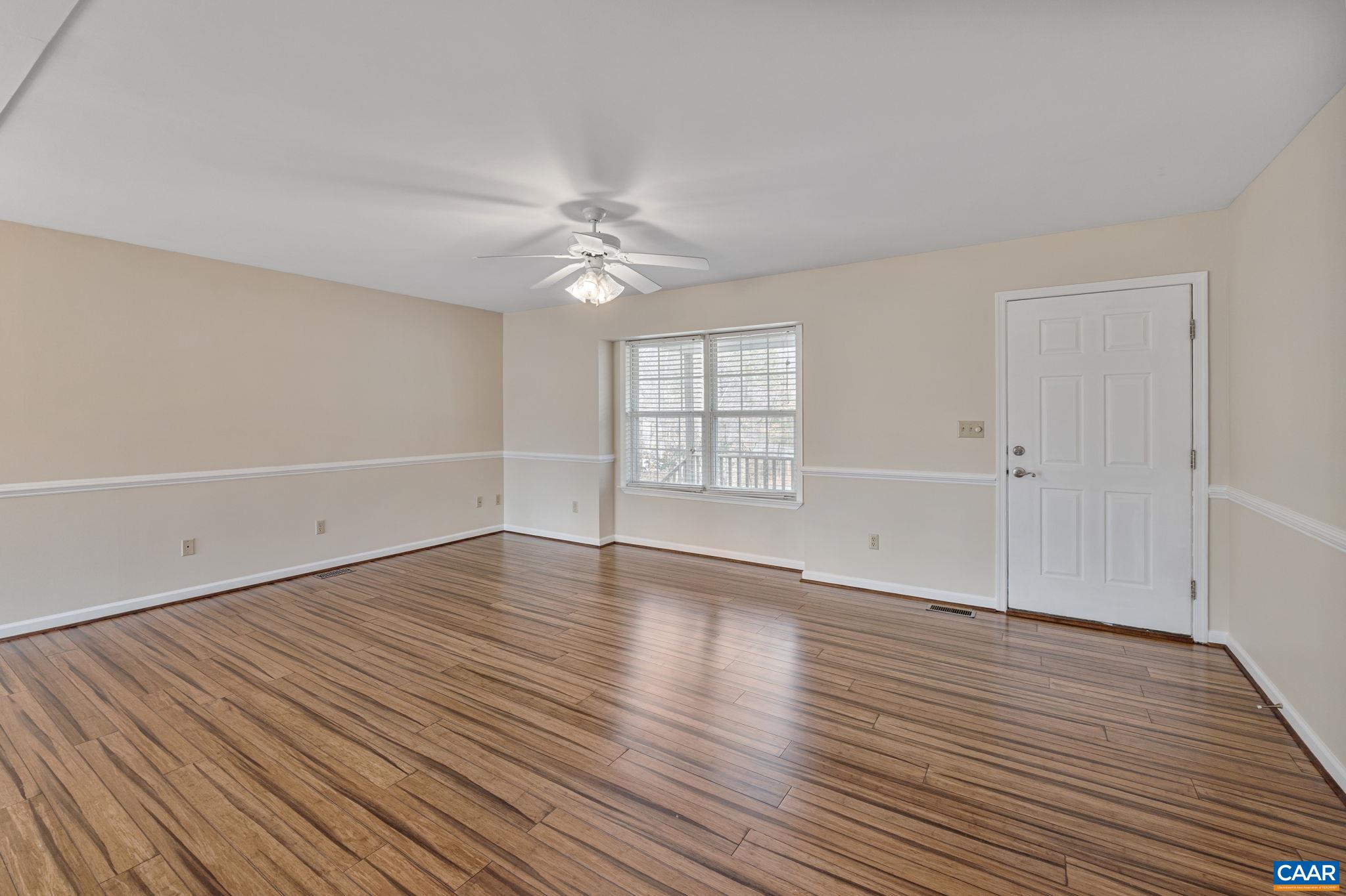 7 Riverside Drive Palmyra, VA 22963 - Photo 8 of 26 an empty room with wooden floor chandelier fan and windows