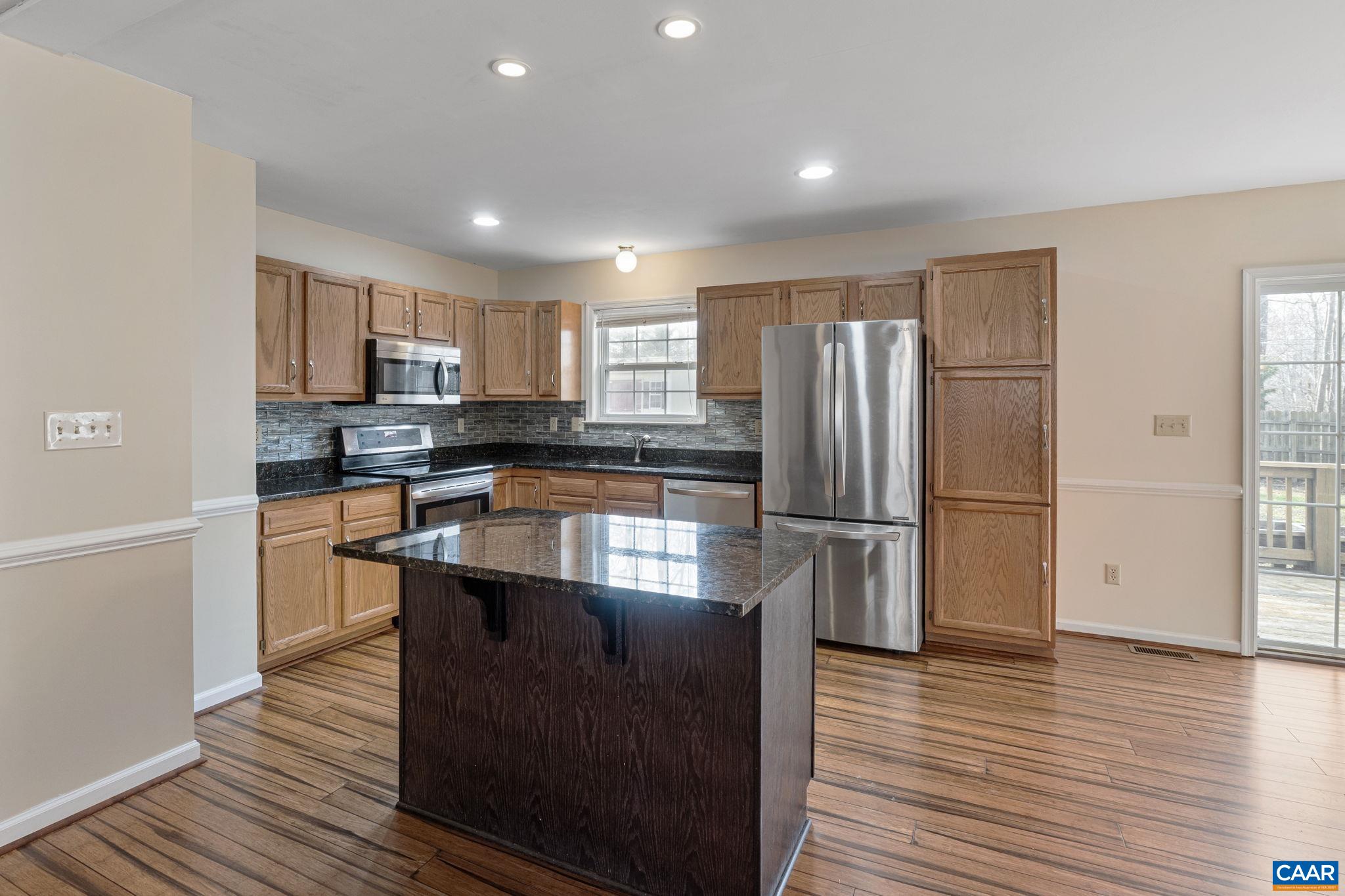 7 Riverside Drive Palmyra, VA 22963 - Photo 10 of 26 a kitchen with stainless steel appliances granite countertop a refrigerator a sink dishwasher a stove and oven with wooden floor
