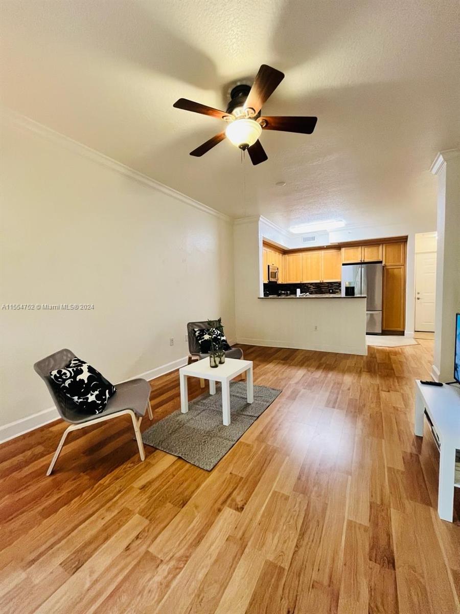 1121 Renaissance Way, Unit 1121 Boynton Beach, FL 33426 - Photo 11 of 26 a living room with furniture and wooden floor
