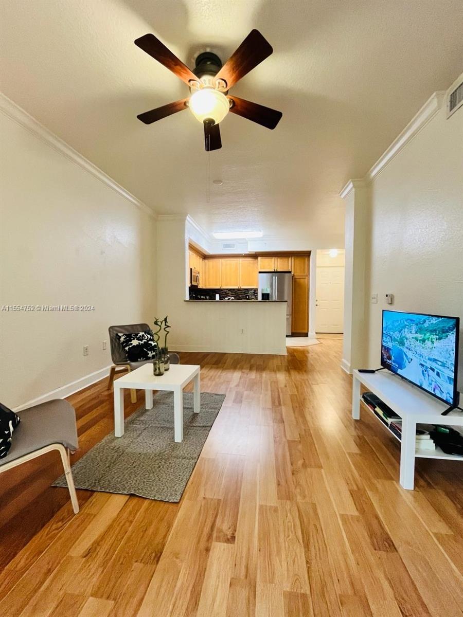 1121 Renaissance Way, Unit 1121 Boynton Beach, FL 33426 - Photo 12 of 26 a living room with a couch and a wooden floor