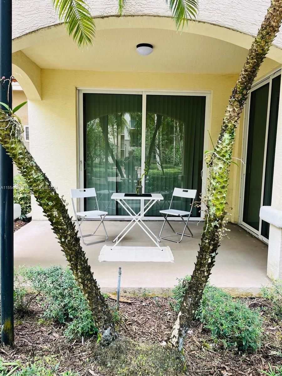 1121 Renaissance Way, Unit 1121 Boynton Beach, FL 33426 - Photo 25 of 26 a view of a house with backyard and porch