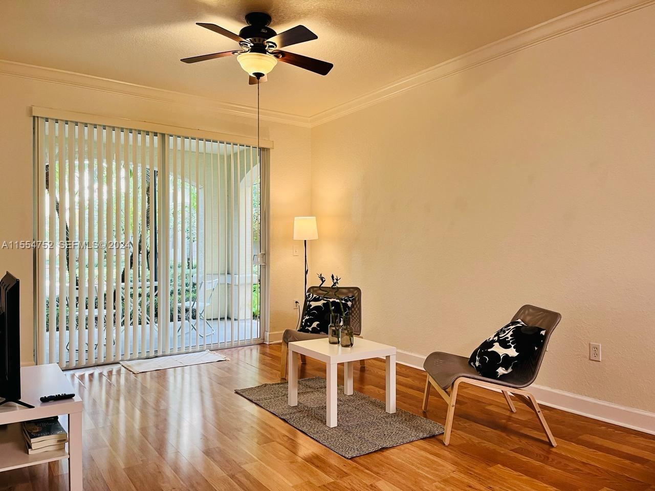 1121 Renaissance Way, Unit 1121 Boynton Beach, FL 33426 - Photo 8 of 26 a living room with furniture and a flat screen tv