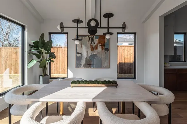a dining table with chairs and window