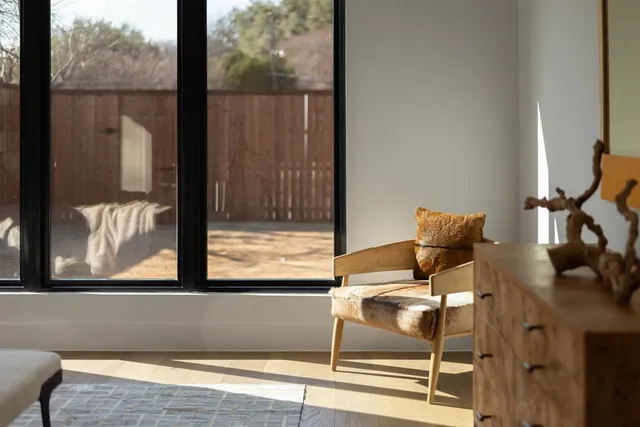 a living room with furniture and a floor to ceiling window