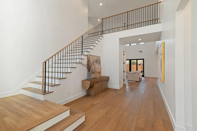 a view of entryway and hall with wooden floor