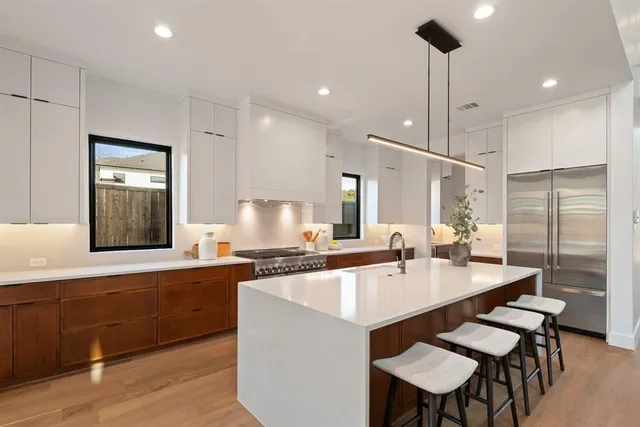 a large kitchen with a table and chairs