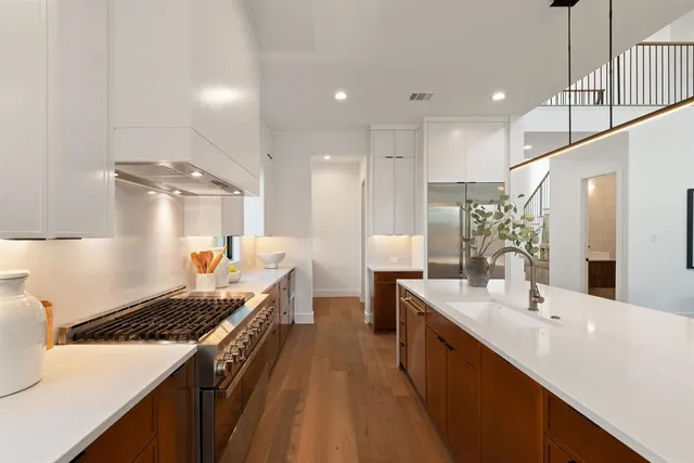 a large kitchen with lots of counter space a sink and appliances