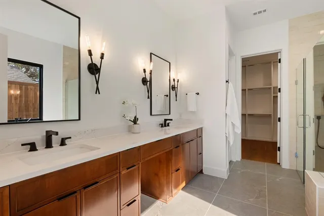 a bathroom with a double vanity sink mirror and double