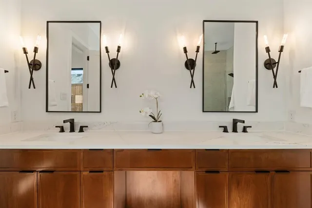 a bathroom with a double vanity sink and mirror