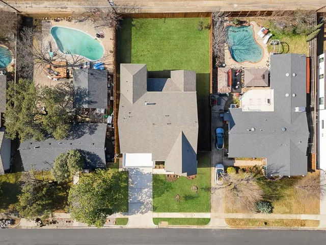 an aerial view of a house with a yard and lake view