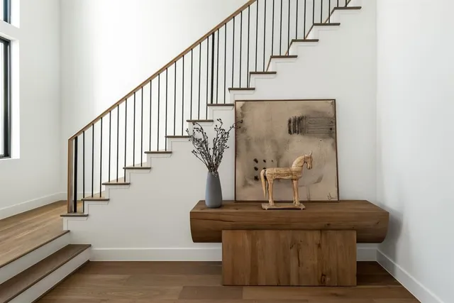 a view of entryway and hall with wooden floor